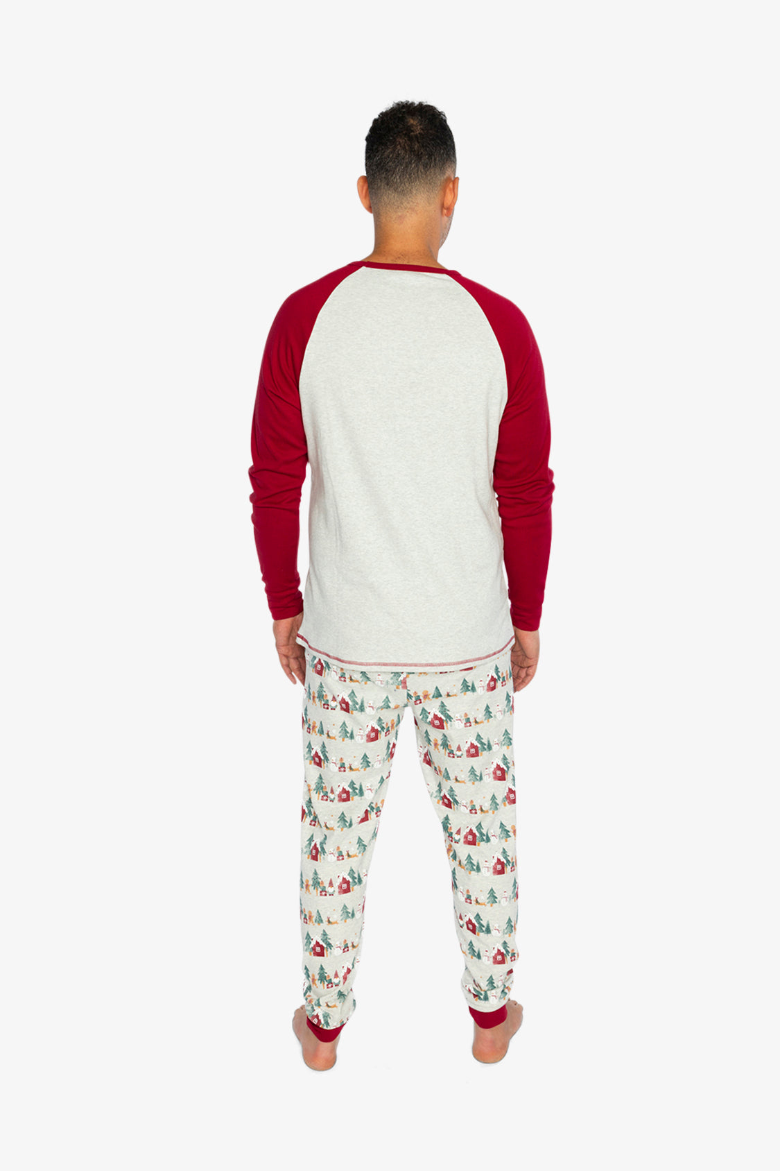 Man wearing the Christmas pajama set from behind with red sleeves and printed pants