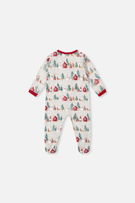 Back view of the beige footed pajama printed with rows of red houses, trees and snowmen