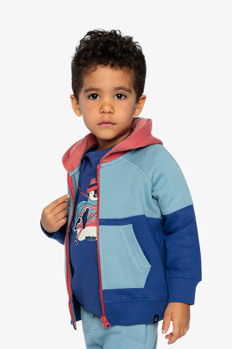 Child wearing the blue colour-block fleece jacket open with a hand on the zipper, three-quarter view
