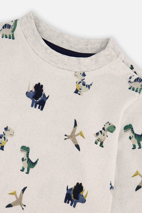 Close-up of the dinosaur print, ribbed neckline and shoulder snaps on the beige Deux par Deux tee