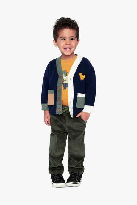 Full-length view of a child in the Deux par Deux navy dino knit cardigan