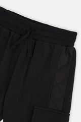 Close-up of the drawstring waistband and quilted side panel on the black cargo sweatpants