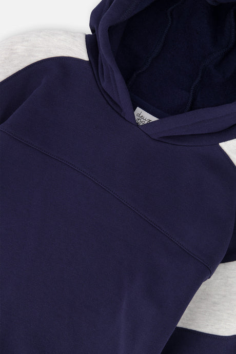 Close-up of the hood and the chest seam on the dark blue Deux par Deux fleece top
