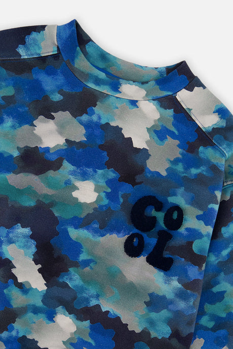 Close-up of the camouflage print and navy COOL chest graphic on the Deux par Deux fleece sweatshirt