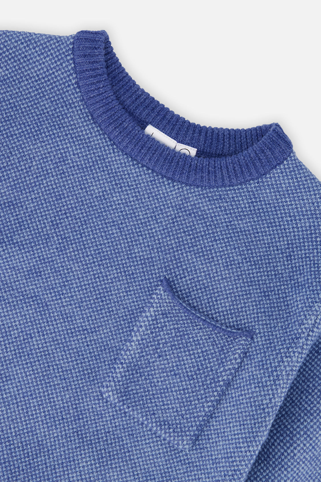 Close-up of the knit texture, ribbed neckline and chest pocket on the Deux par Deux blue sweater