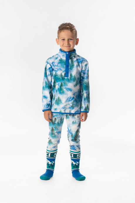 Child wearing the blue mountain print fleece pullover over mountain print pants and ski socks, front view