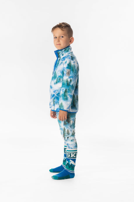 Child wearing the blue mountain print fleece pullover, side view with sleeve label