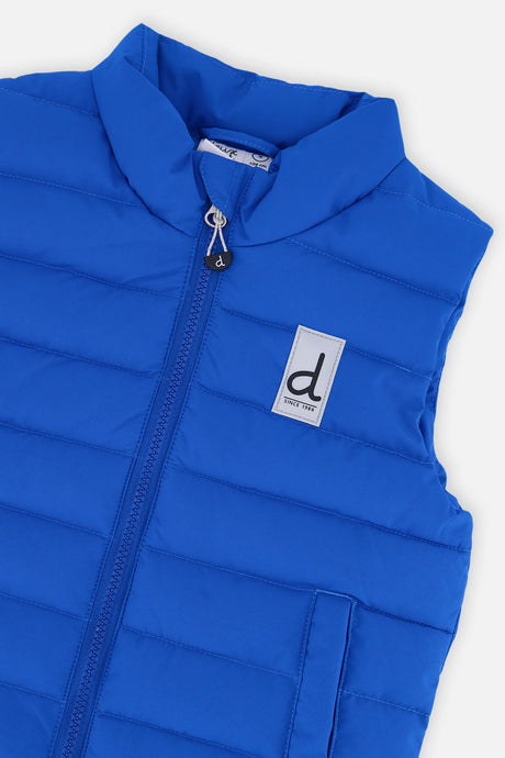 Close-up of the stand collar, zipper and logo patch on the blue quilted vest