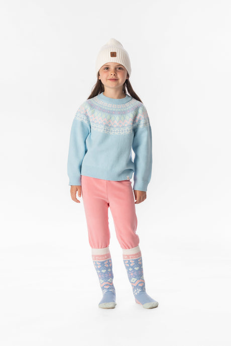 Child wearing the light blue Fair Isle knit sweater with pink pants and a white beanie, front view