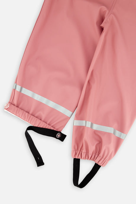 Close-up of the ankle cuffs and reflective strips on the pink Deux par Deux rain overalls