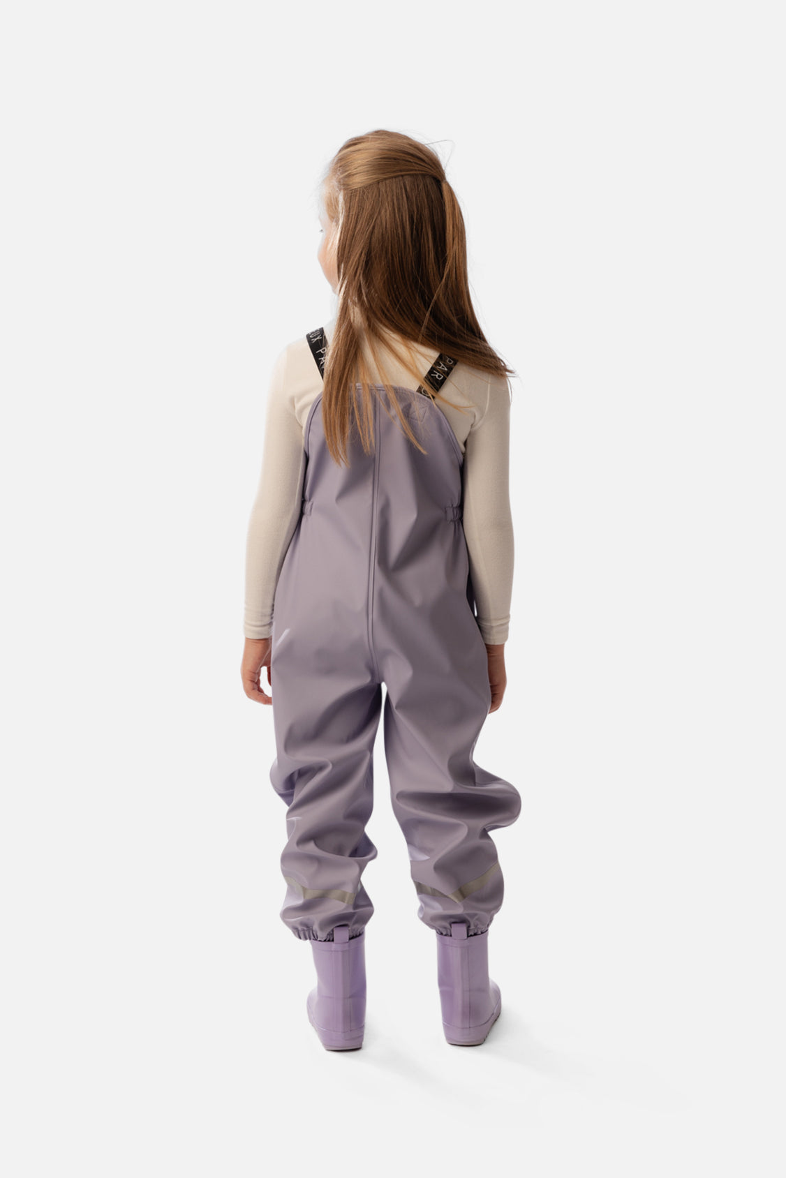 Child wearing the Deux par Deux mauve rain overalls, back view