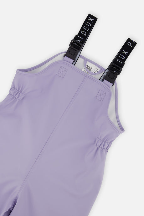 Close-up of the mauve rain overalls bib with Deux par Deux logo suspenders and buckles