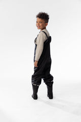 Child in the Deux par Deux black waterproof rain overalls, lifestyle photo