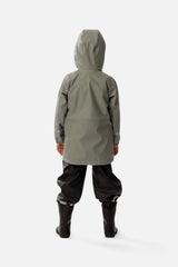 Child wearing the sage green rain jacket, back view with the hood up