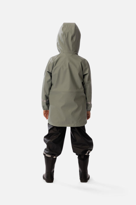Child wearing the sage green rain jacket, back view with the hood up