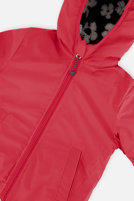 Close-up of the pink coated side, zipper and hood of the reversible jacket
