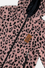 Close-up of the pink sherpa with black leopard-style spots and the front zip on the reversible jacket