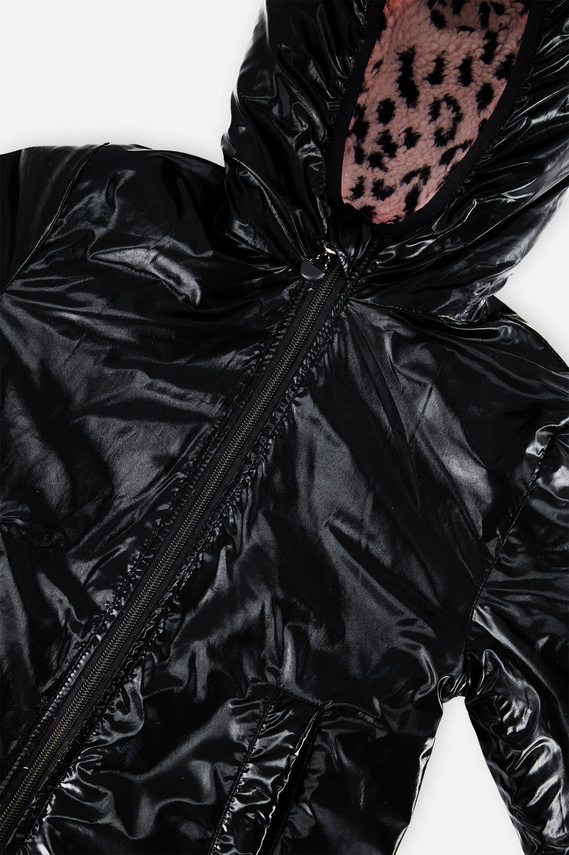 Close-up of the glossy black side and the sherpa-lined hood opening of the reversible jacket