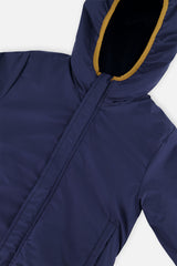 Close-up of the dark blue coated side and the hood opening of the reversible jacket