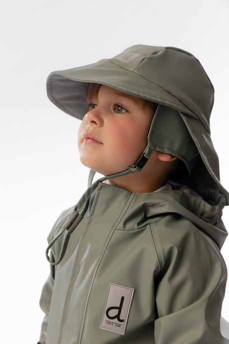Child wearing the Deux par Deux sage green rain bucket hat outdoors