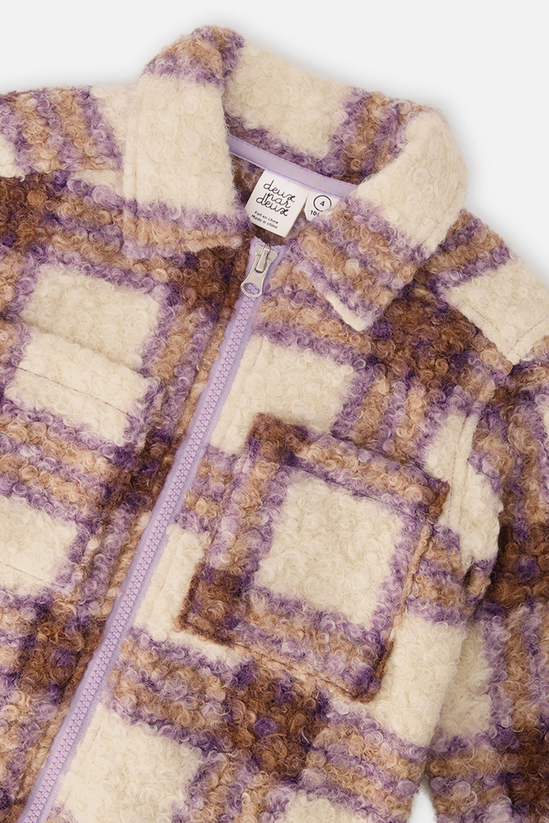 Close-up of the looped sherpa plaid collar and chest pocket on the overshirt