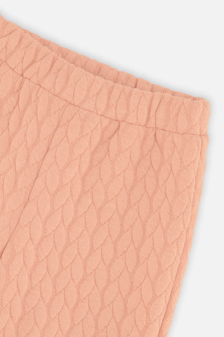Close-up of the Wide Leg Jacquard Pants Pink quilted fabric and elastic waist