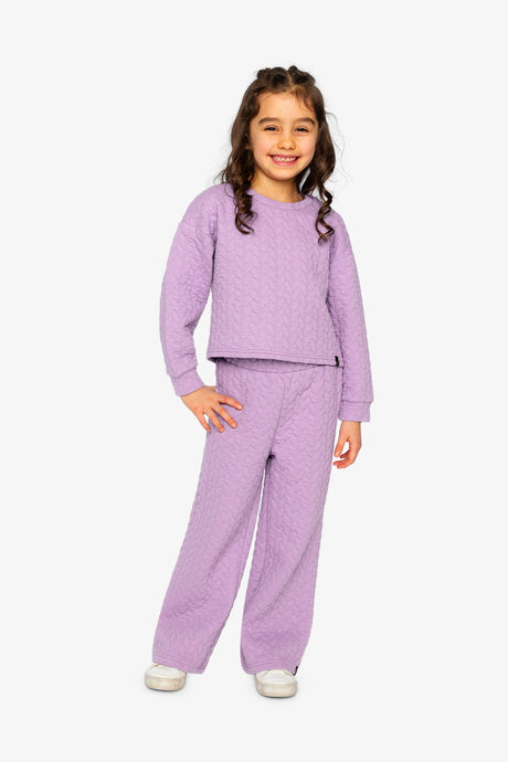 Child wearing the Jacquard Sweatshirt Purple in a full-length outfit