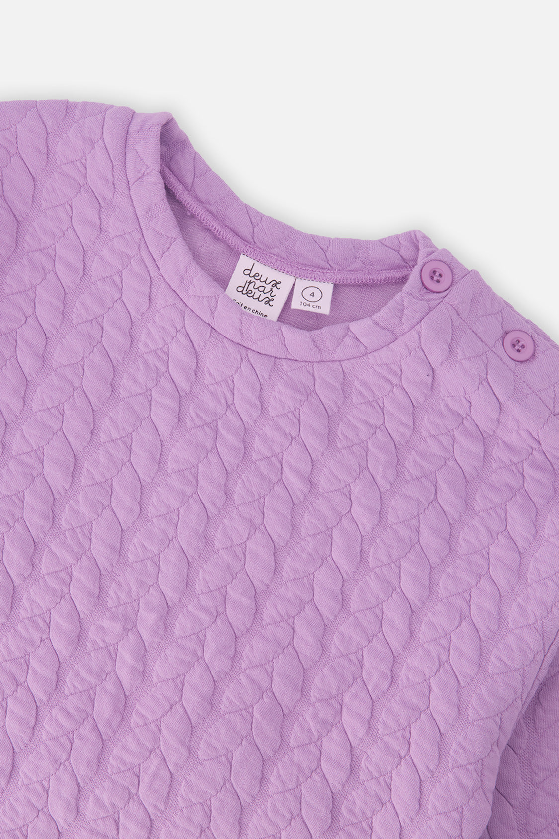 Close-up of the Jacquard Sweatshirt Purple neckline and shoulder buttons