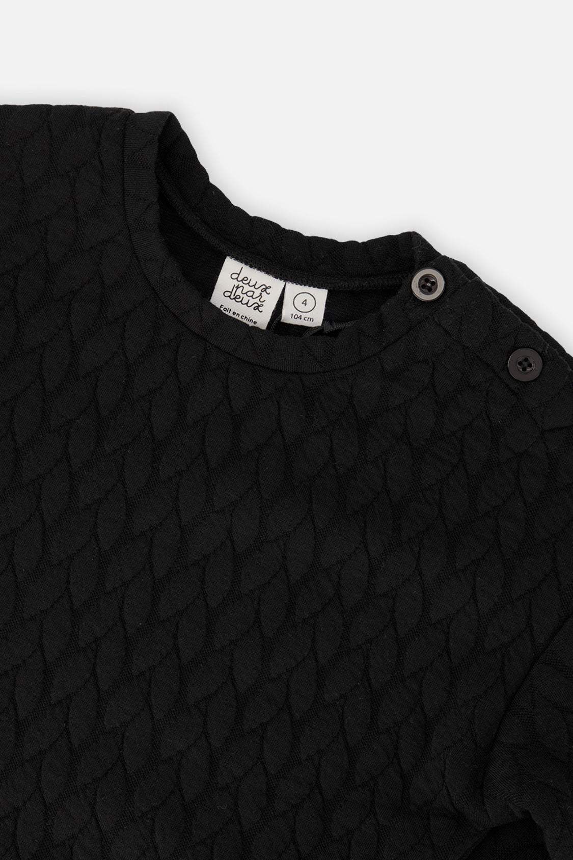 Close-up of the Jacquard Sweatshirt Black neckline and shoulder buttons