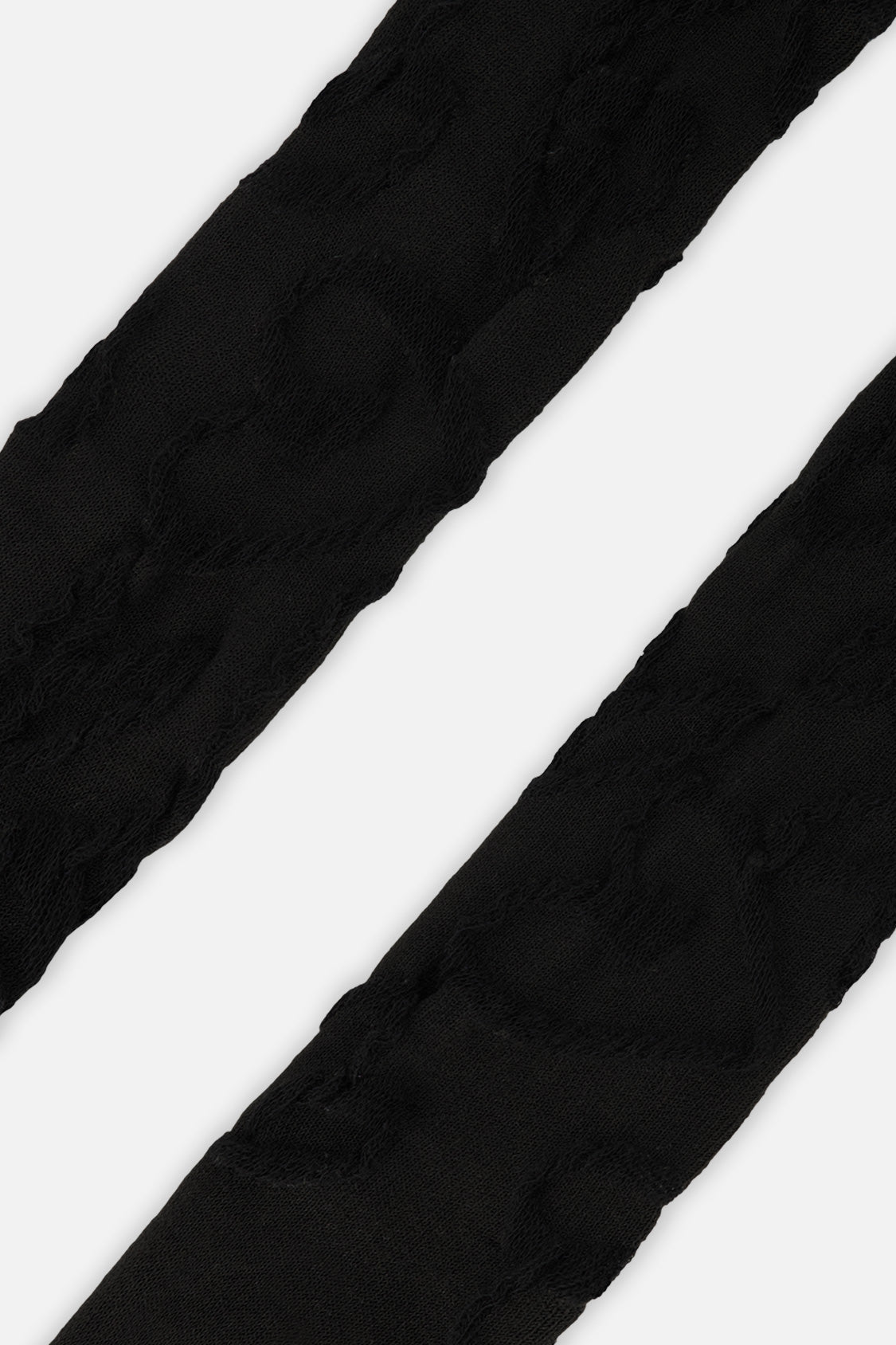 Close-up of the tonal textured pattern on the black Deux par Deux baby tights