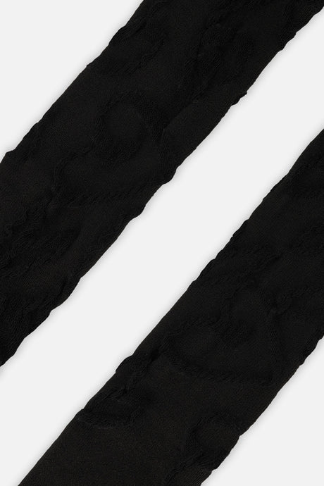 Close-up of the tonal textured pattern on the black Deux par Deux baby tights