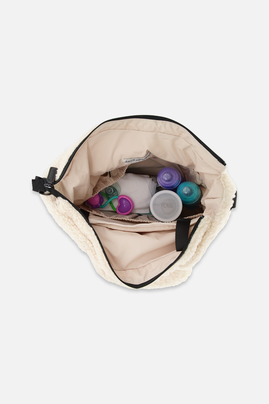 Open off-white diaper bag showing bottles inside the beige lined interior