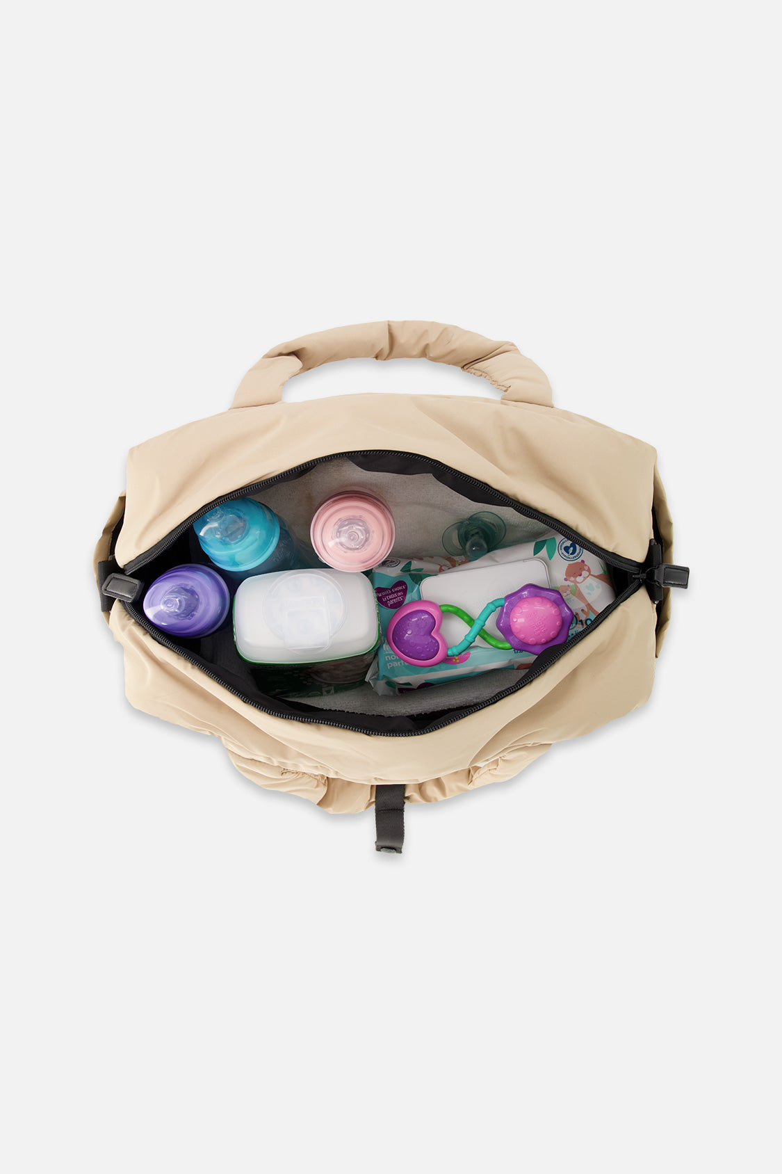 Top view of the open beige diaper bag packed with bottles, wipes and baby items