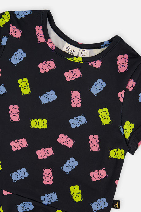 Close-up of the neckline and pink and blue and lime gummy bear print on the Deux par Deux dress