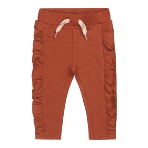 Front view of Arabian-spice Dirkje girls sweatpants with side ruffles