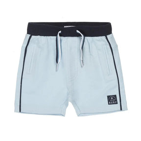 Front view of light blue Dirkje boys shorts with navy waistband and side piping