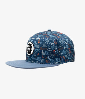 Blue Peace Out kids snapback with multicolor doodle print and slate-blue brim, angled front view