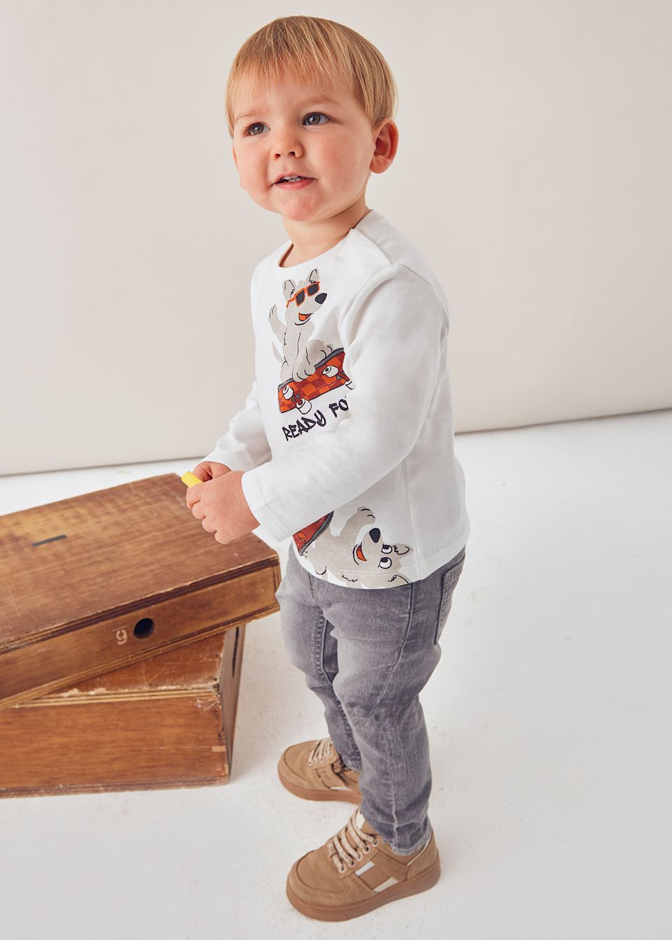 Toddler side view showing relaxed fit and soft cotton jersey.