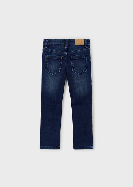 Full view of kids slim jeans in dark denim showing neat silhouette.
