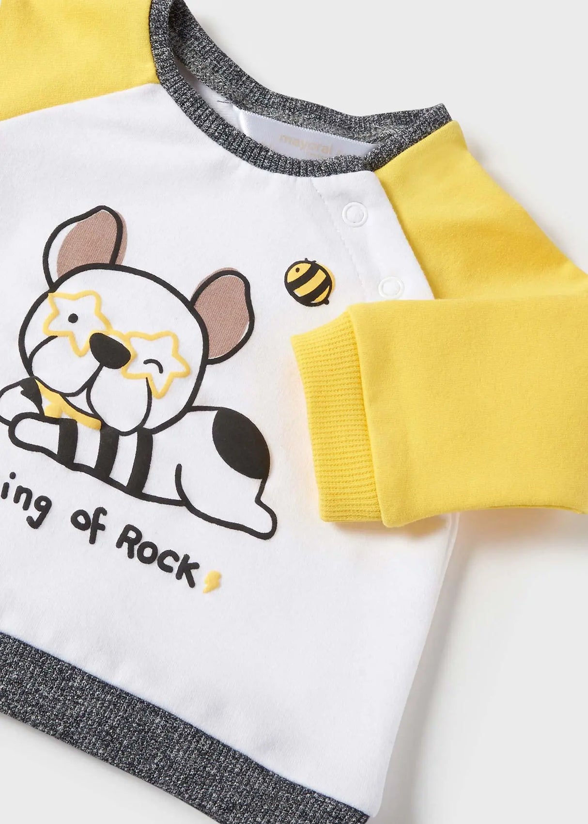 Closeup of shoulder snap buttons and soft knit neckline.