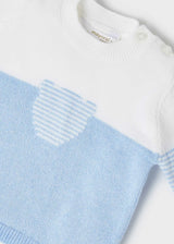 Closeup of fine-gauge knit and chest pocket detail on jumper.