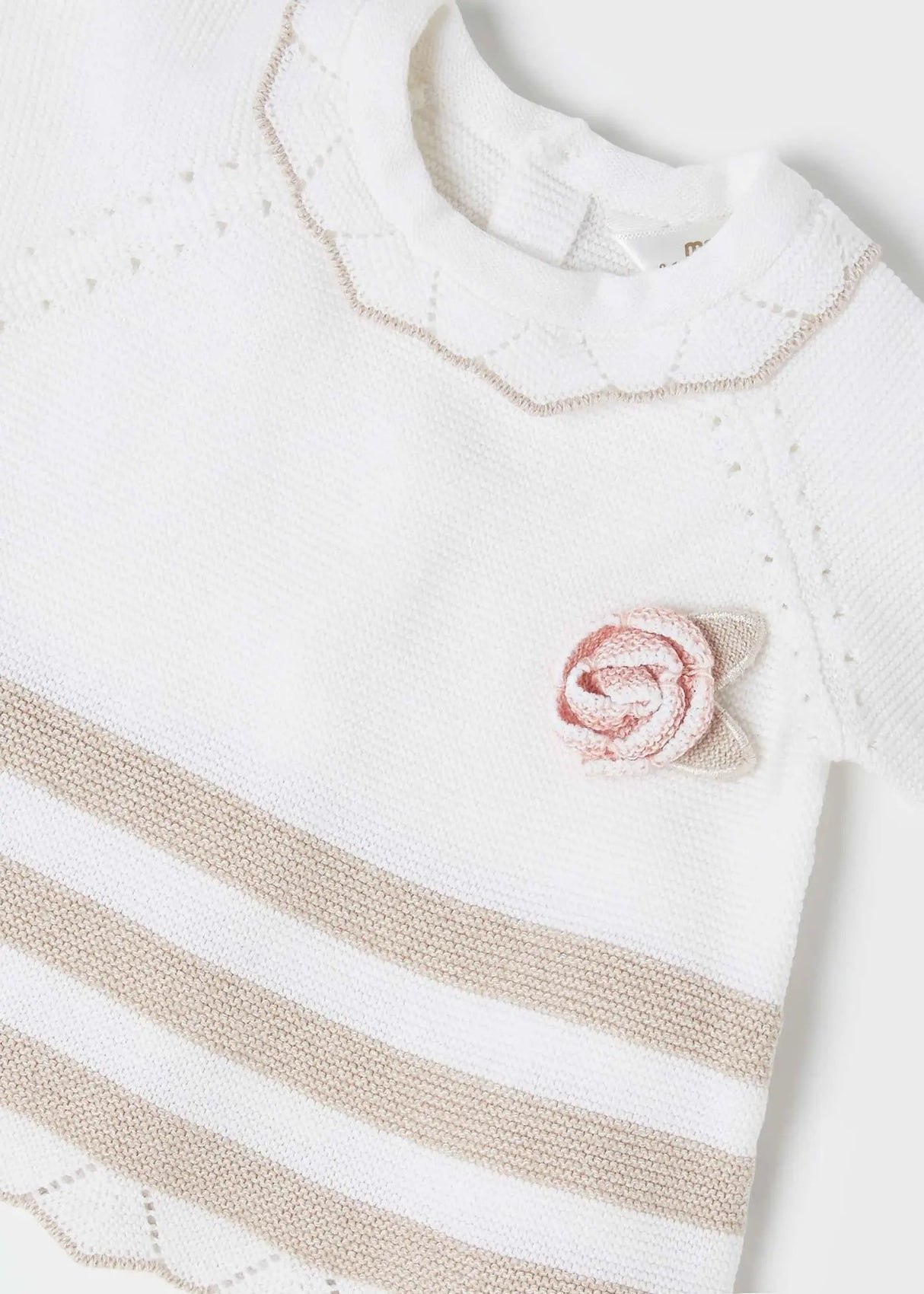 Closeup of fine-gauge knit and neck/applique detail on jumper.