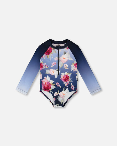 Front flat lay of Deux par Deux girl one-piece long sleeve rashguard in Blue Rose print