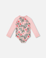 Back view of pink hibiscus long sleeve rashguard one-piece for girls