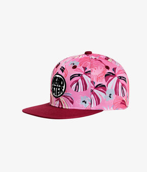 Pink Panama kids snapback with tropical leaves and raspberry-red brim, angled front view