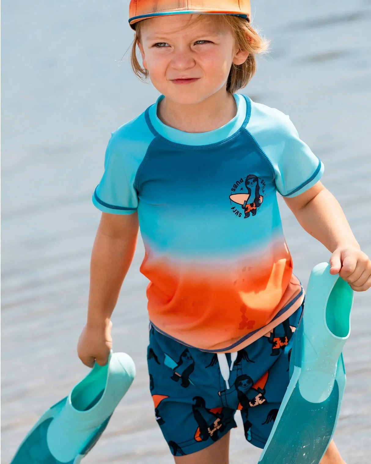 Printed Swim Trunks Orange Sloths On Navy Blue | Deux par Deux | Jenni Kidz