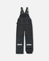 Back view of Solid Black snow overalls with elastic waistband.
