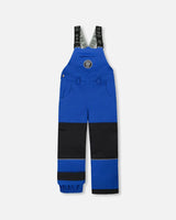 Flat lay of boys Solid Blue snow bib overall with reinforced knees.