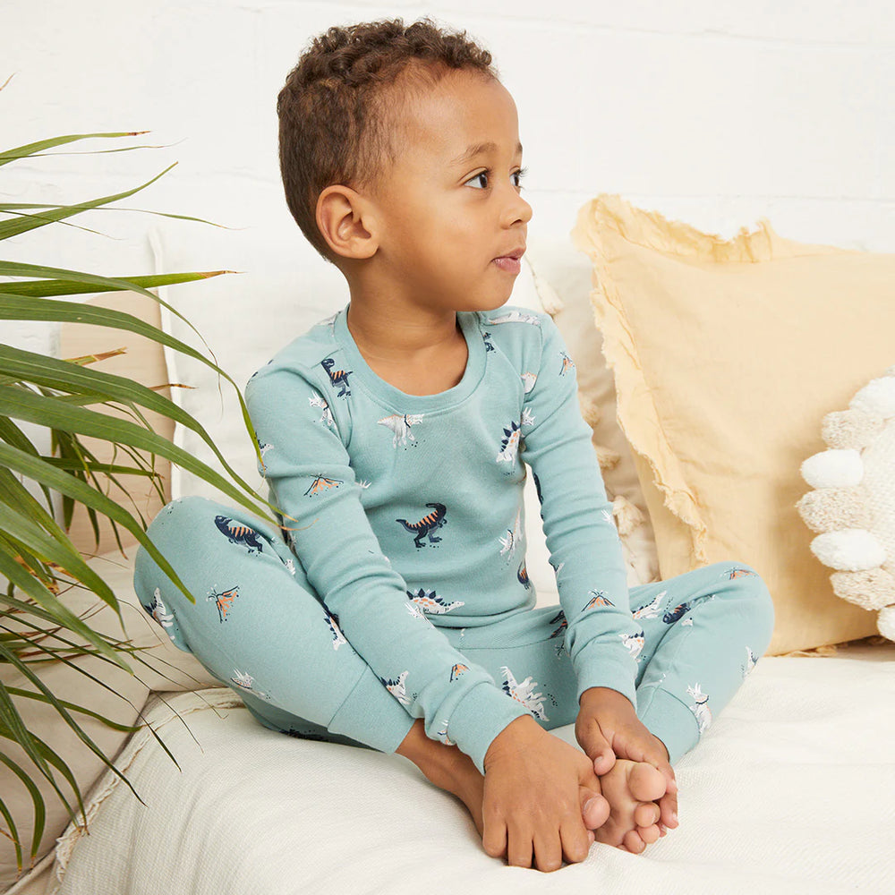 Toddler wearing tidal wave green dinosaur print organic cotton pajama set by Petit Lem