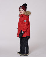 Model in two-piece ski suit black, detachable hood with faux-fur — limited stock